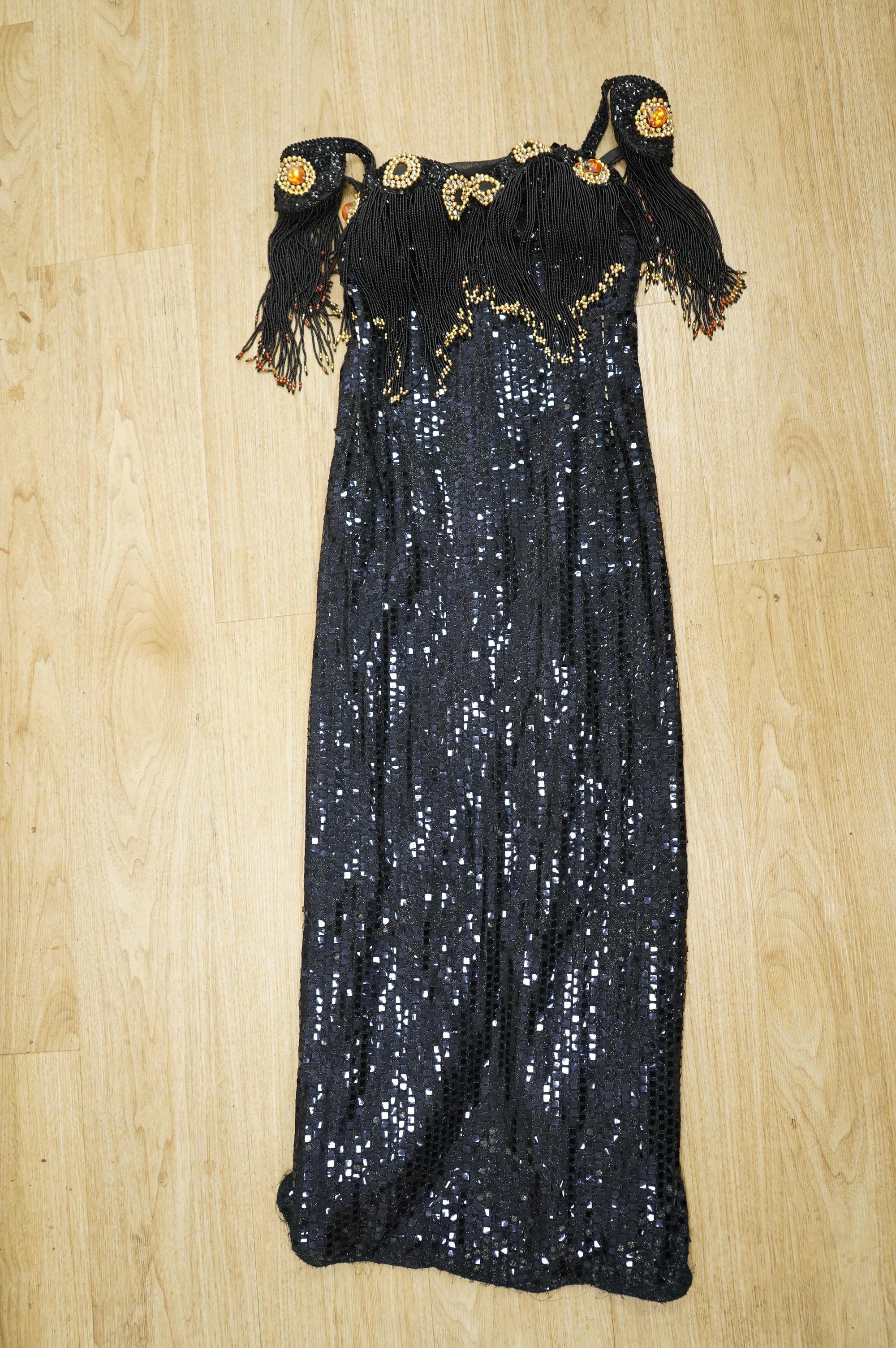 A late 20th century black sequinned, beaded and fringed evening dress, bust 36cm wide at front, together with a lilac chiffon, net, lace and sequin top and matching net evening skirt. Both outfits are a small size